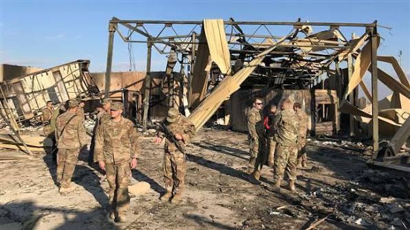 remains of a building after Iranian attacks with some US soldiers walking around